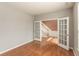 Open office space with hardwood floors and glass French doors leading to the foyer at 5344 Misthaven Ln, Greenwood, IN 46143