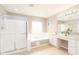 Well-lit bathroom features a bathtub, shower, vanity with double sinks, and vanity area at 5769 Marsh Glen Ct, Carmel, IN 46033