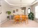 Warm and inviting dining room features natural wood furniture, complemented by a tray ceiling and stylish decor at 5769 Marsh Glen Ct, Carmel, IN 46033