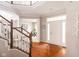 Grand foyer with hardwood floors, elegant staircase, and an open view into the inviting living spaces of the home at 5769 Marsh Glen Ct, Carmel, IN 46033