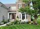 Charming brick home with manicured front yard landscaping and welcoming front porch at 5769 Marsh Glen Ct, Carmel, IN 46033