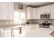 Bright kitchen featuring white cabinets, modern appliances, and ample counter space with a view from the window at 5769 Marsh Glen Ct, Carmel, IN 46033
