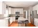 Well-lit kitchen with white cabinets, stainless steel appliances, and a convenient center island with barstool seating at 5769 Marsh Glen Ct, Carmel, IN 46033