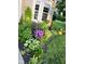 Well-maintained landscaping with a flowerbed, green lawn, and a bay window at 5769 Marsh Glen Ct, Carmel, IN 46033