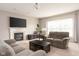 Open living room with fireplace, large windows, and comfortable seating for relaxing at 5769 Marsh Glen Ct, Carmel, IN 46033
