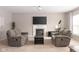 Cozy living room with a fireplace, comfortable seating, and a TV, perfect for relaxation and entertainment at 5769 Marsh Glen Ct, Carmel, IN 46033