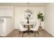 Cozy dining area with a modern chandelier, round glass table and seating for four at 6014 Wildcat Dr, Indianapolis, IN 46203