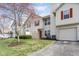 Well-maintained townhome exterior with red shutters and a driveway leading to a garage at 6014 Wildcat Dr, Indianapolis, IN 46203