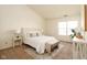 Comfortable main bedroom with a queen sized bed, bench, side tables, and a large window at 6014 Wildcat Dr, Indianapolis, IN 46203
