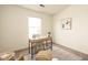 Bright home office with a wooden desk, chair, and natural light from the window at 6014 Wildcat Dr, Indianapolis, IN 46203