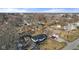 An aerial view displays the property within its neighborhood surrounded by mature trees at 6470 Jackson St, Indianapolis, IN 46241