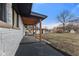 Back of house with patio and view of backyard with storage sheds and a large lawn at 6470 Jackson St, Indianapolis, IN 46241