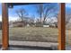 Large backyard with mature trees and several storage sheds at 6470 Jackson St, Indianapolis, IN 46241