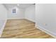 Finished basement with wood look floors and bright light at 6470 Jackson St, Indianapolis, IN 46241