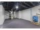 View of the unfinished basement with concrete floors, white walls, and equipment at 6470 Jackson St, Indianapolis, IN 46241