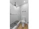 Modern bathroom with black and white tile shower and wood look flooring at 6470 Jackson St, Indianapolis, IN 46241