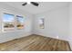 Bright bedroom featuring wood-look flooring, neutral walls, and multi-pane windows for natural light at 6470 Jackson St, Indianapolis, IN 46241
