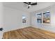 Bright bedroom featuring wood-look flooring, neutral walls, and double windows for natural light at 6470 Jackson St, Indianapolis, IN 46241