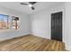 Bright bedroom with natural light, neutral walls, ceiling fan, and wood-look flooring at 6470 Jackson St, Indianapolis, IN 46241