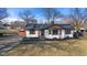 Charming exterior showcasing a brick home with a dark roof, wood accents, and a well-maintained front yard at 6470 Jackson St, Indianapolis, IN 46241