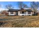 Delightful single-story home presenting a classic facade, a cozy entrance, and a tidy lawn at 6470 Jackson St, Indianapolis, IN 46241