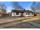 Attractive home featuring a bright exterior, complemented by a detached garage and neatly kept landscaping at 6470 Jackson St, Indianapolis, IN 46241