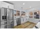 Bright and airy kitchen showcasing stainless steel appliances, white cabinets, and generous counter space at 6470 Jackson St, Indianapolis, IN 46241