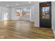 Spacious living room featuring bright light, wood look floors and large windows at 6470 Jackson St, Indianapolis, IN 46241