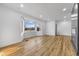 Inviting living room featuring light-colored walls, wood-look floors, and a large bay window with neighborhood views at 6470 Jackson St, Indianapolis, IN 46241