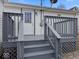 Back porch and stairs with gray painted wood and railings at 718 Indiana Ave, Shelbyville, IN 46176