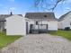 Backyard featuring a small deck, gravel, and a detached garage at 718 Indiana Ave, Shelbyville, IN 46176