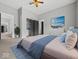 Bedroom with soft blue accents, gray walls, closet, and doorway leading into additional room at 718 Indiana Ave, Shelbyville, IN 46176