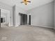 Spacious bedroom with plush carpet, gray walls, closet, and doorway leading to other rooms at 718 Indiana Ave, Shelbyville, IN 46176