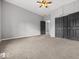Bedroom boasts neutral colors, plush carpet, closet, gray doors, and ample space at 718 Indiana Ave, Shelbyville, IN 46176