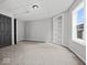 Bedroom with grey walls, plush carpet, built-in shelving, and doorway to adjoining room at 718 Indiana Ave, Shelbyville, IN 46176