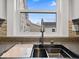 A view of the kitchen sink overlooking the neighborhood at 718 Indiana Ave, Shelbyville, IN 46176