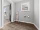 Utility room with wood-look flooring and neutral-painted walls at 718 Indiana Ave, Shelbyville, IN 46176