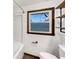 Bathroom featuring a shower with a window, new fixtures, and rustic shelves at 719 Howard Rd, Greenwood, IN 46142