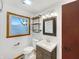 Updated bathroom featuring a modern vanity, new fixtures, and rustic shelving at 719 Howard Rd, Greenwood, IN 46142