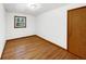 Bedroom features hardwood floors, a window, and a wood paneled door at 719 Howard Rd, Greenwood, IN 46142