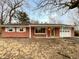 Charming single-story brick home featuring an attached garage and covered front porch at 719 Howard Rd, Greenwood, IN 46142