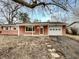 Charming single-story brick home featuring an attached garage and covered front porch at 719 Howard Rd, Greenwood, IN 46142