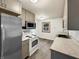 Kitchen featuring stainless steel appliances, new cabinets and countertops, and wood laminate flooring at 719 Howard Rd, Greenwood, IN 46142