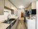 Modern kitchen features updated cabinets, stainless steel appliances, and hardwood floors at 719 Howard Rd, Greenwood, IN 46142