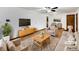 Staged living room features a plush sofa, chairs, area rug, and large-screen TV at 719 Howard Rd, Greenwood, IN 46142