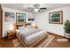 Staged bedroom features a platform bed, two windows, and hardwood floors at 719 Howard Rd, Greenwood, IN 46142