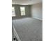 Spacious bedroom showcasing plush carpet, natural light, and neutral paint at 764 Oakleaf Dr, Greenfield, IN 46140