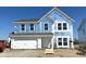 Exterior view of new two-story home under construction with attached two-car garage and blue sky background at 764 Oakleaf Dr, Greenfield, IN 46140