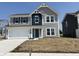Charming two-story home featuring gray siding, blue shutters, and a two-car garage at 764 Oakleaf Dr, Greenfield, IN 46140