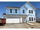 Exterior view of a new two-story home featuring a garage, still under construction, against a clear sky at 764 Oakleaf Dr, Greenfield, IN 46140